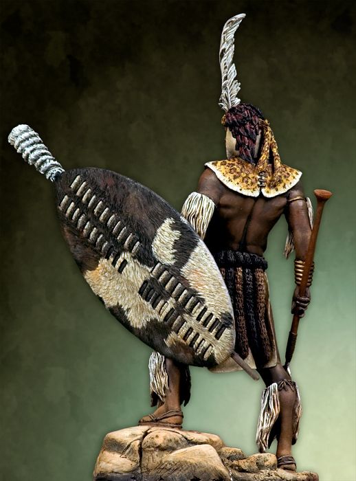 Zulu warrior in traditional attire carrying a shield